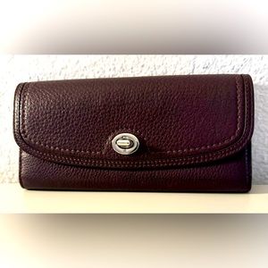 Gently used purple Coach wallet with silver hardware.